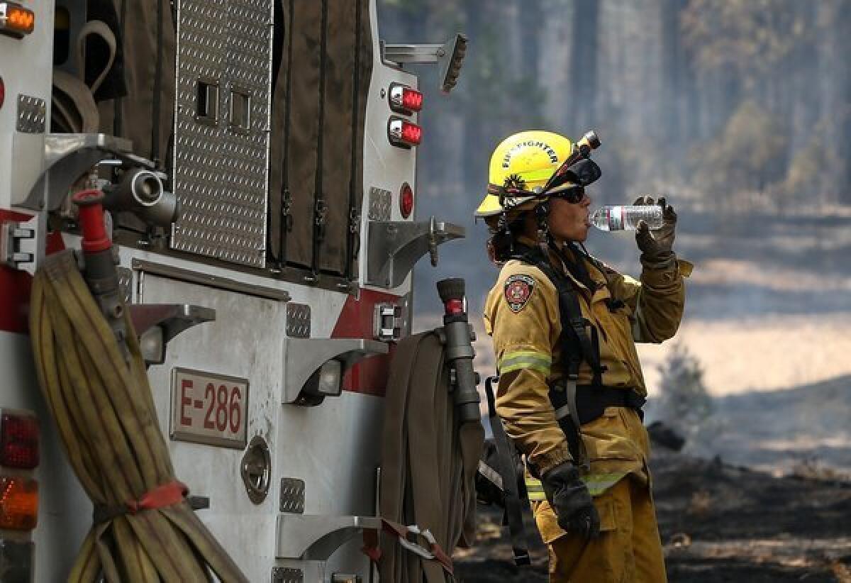 An El Dorado Hills firefighter takes a break from battling the Rim Fire Wednesday near Groveland.