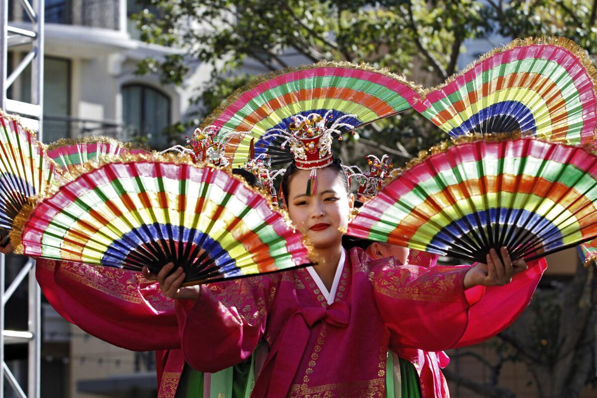A member of the Jung Im Lee Korean Dance Academy performs the Korean fan dance during the Americana at Brand's Lunar New Year celebration in Glendale on Saturday, Feb. 1, 2014. The Americana at Brand kicked off the Year of the Horse with a festival of cultural heritage for the entire family.