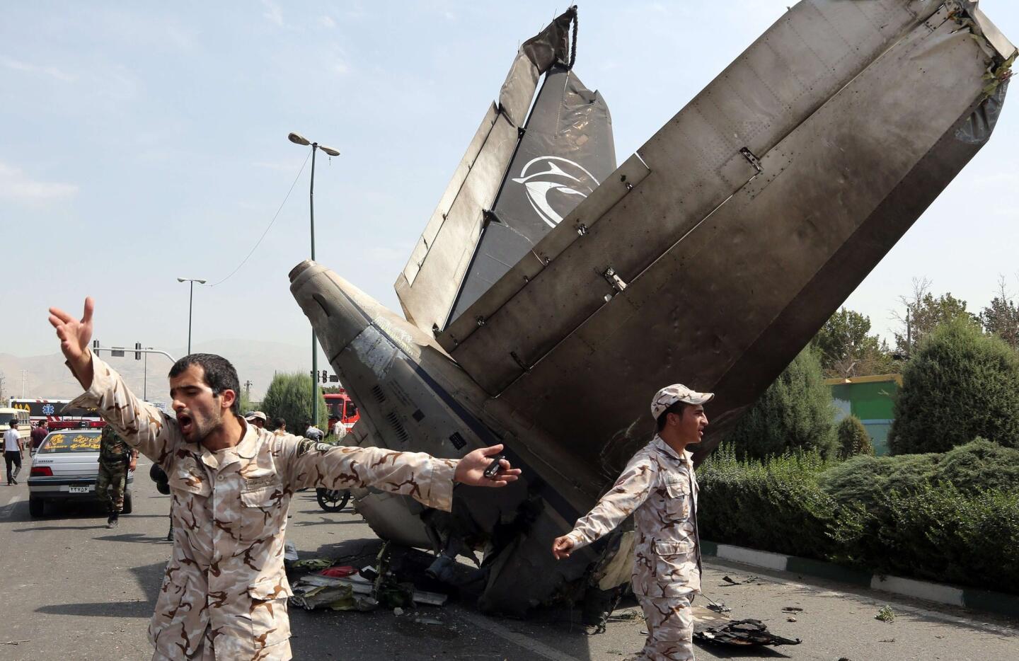 Iranian forces secure the scene of a plane crash near Tehran's Mehrabad Airport.