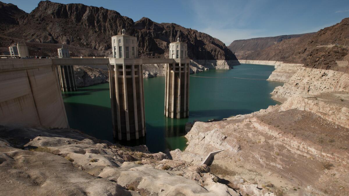 Falling fast: Dwindling water levels last year exposed the white "bathtub ring" on Lake Mead and the water intakes for Hoover Dam's hydroelectric generators. The lake is lower now.