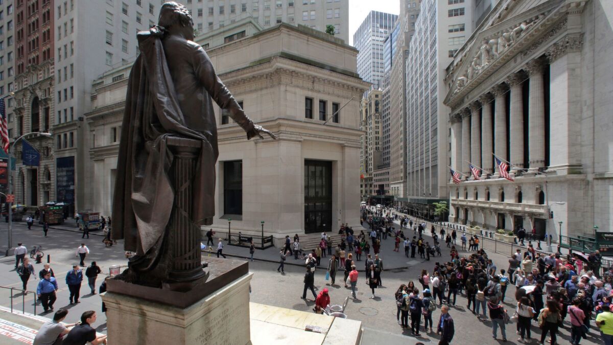 A statue of George Washington, on the steps of the Federal Hall National Monument, overlooks Wall Street and the New York Stock Exchange in May 2016.