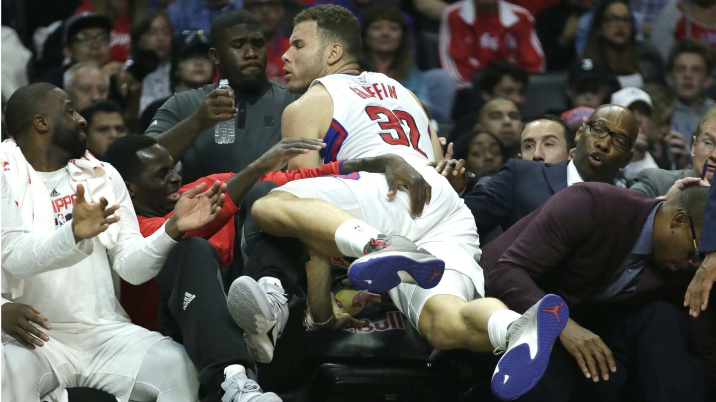 Blake Griffin lands on Clippers teammates as he dives for a loose ball during first half action.