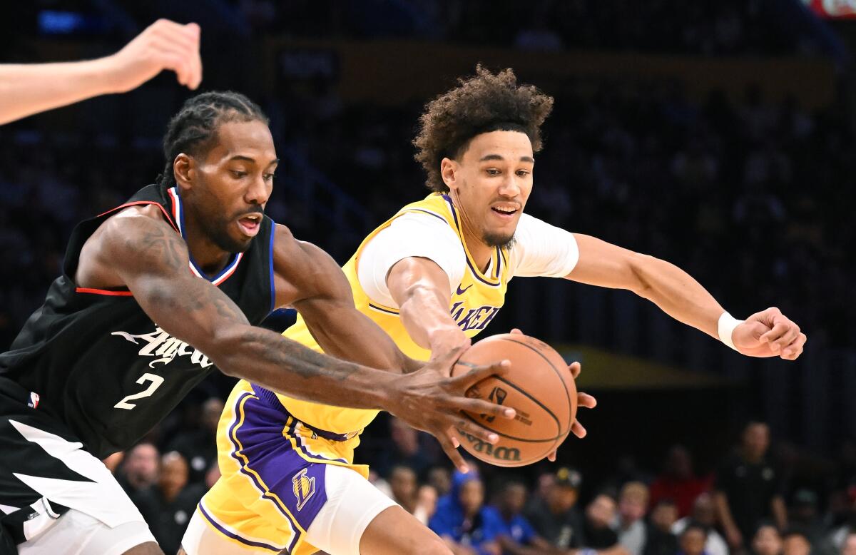 The Clippers’ Kawhi Leonard, left, and Lakers’ Jaxson Hayes battle for a loose ball