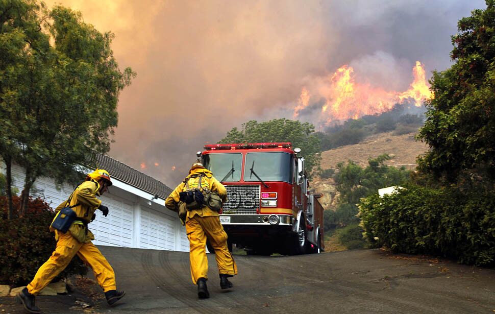 Firefighters work to contain the blaze in Hidden Valley.