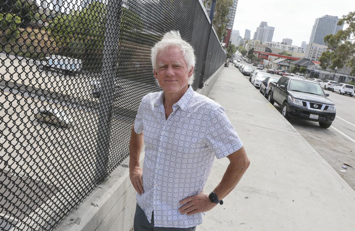 Roger Lewis, of the nonprofit San Diego Commons, stands on the Island Avenue overpass Wednesday in San Diego.