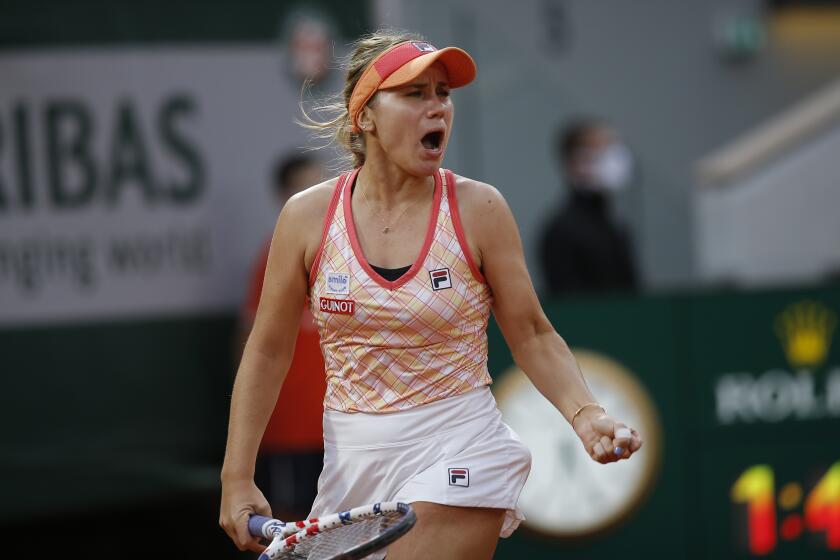 Sofia Kenin of the U.S. clenches her fist after scoring a point against Petra Kvitova of the Czech Republic in the semifinal match of the French Open tennis tournament at the Roland Garros stadium in Paris, France, Thursday, Oct. 8, 2020. (AP Photo/Michel Euler)