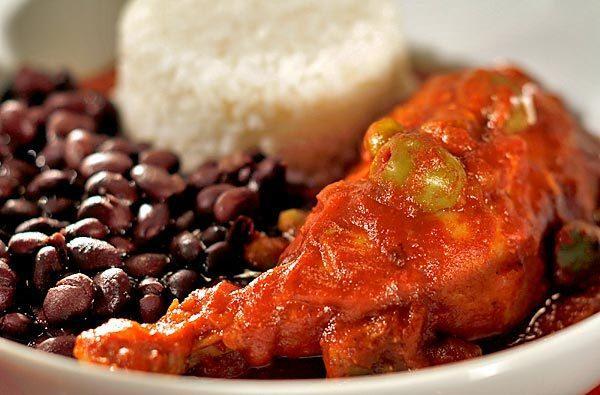 The specialty features tender, slow-cooked chicken stewed in a Creole-style tomato sauce dotted with green olives and peas and spiced with chile powder. Recipe: Pollo al Colmao