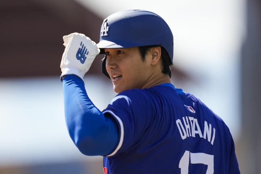Los Angeles Dodgers designated hitter Shohei Ohtani stands on third base during the first inning of a spring training baseball game against the Colorado Rockies in Phoenix, Sunday, March 3, 2024. (AP Photo/Ashley Landis)