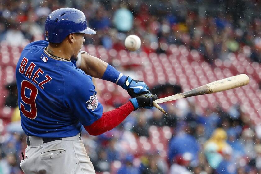 Javier Baez breaks his bat on a foul tip off Reds starting pitcher John Lamb in the fifth inning.