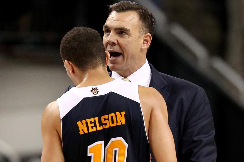 UC Irvine Coach Russell Turner talks to guard Luke Nelson during their 57-55 loss to Louisville on Friday in Seattle.