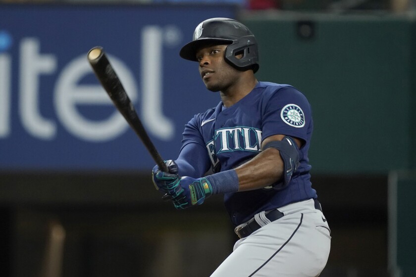 Seattle Mariners' Justin Upton watches his ground ball during the fourth inning of the team's baseball game against the Texas Rangers, Friday, July 15, 2022, in Arlington, Texas. A run scored, and Upton reached on a fielding error. (AP Photo/Tony Gutierrez)