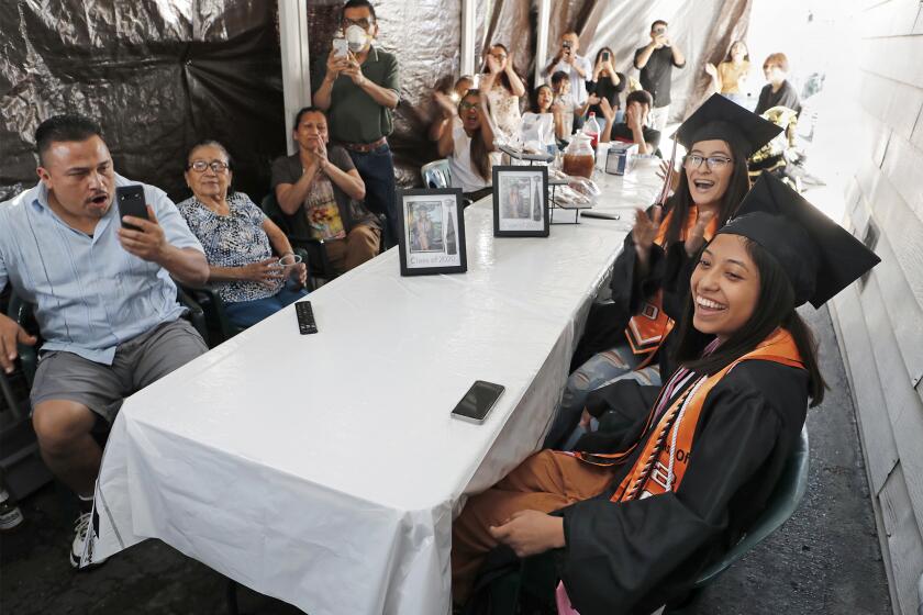 Alexandra Lopez, 17, bottom right, is celebrated by family and friends as they gather at her home in Santa Ana on Friday to watch a virtual graduation ceremony for Los Amigos High School's Class of 2020.