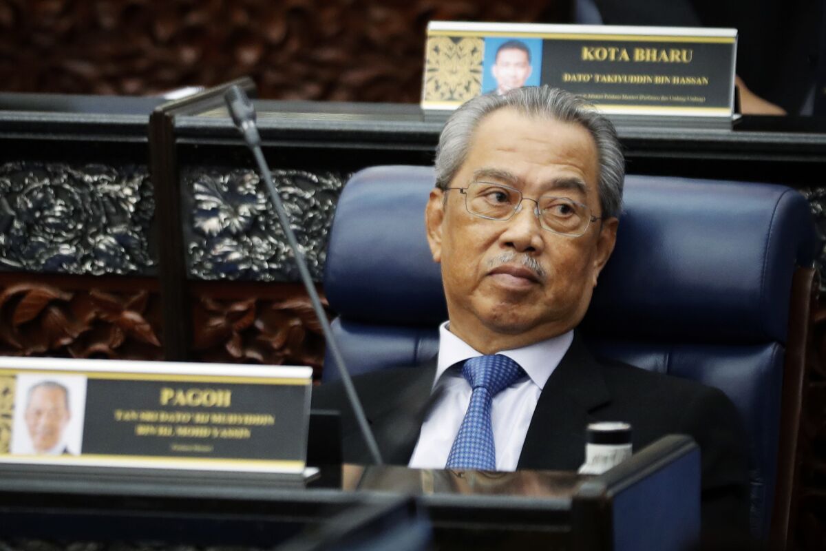 FILE - In this July 13, 2020, file photo, Malaysian Prime Minister Muhyiddin Yassin attends a Parliament session at lower house in Kuala Lumpur, Malaysia. Embattled Prime Minister Yassin acknowledged Friday, Aug. 13, 2021, he may have lost majority support in Parliament but said he will seek bipartisan support to keep his government from collapsing and promised to call for election next year. (AP Photo/Vincent Thian, File)