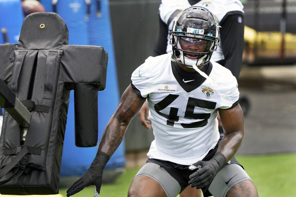 Jacksonville Jaguars K'Lavon Chaisson (45) performs a drill during an NFL football practice, Tuesday, May 31, 2022, in Jacksonville, Fla. (AP Photo/John Raoux)