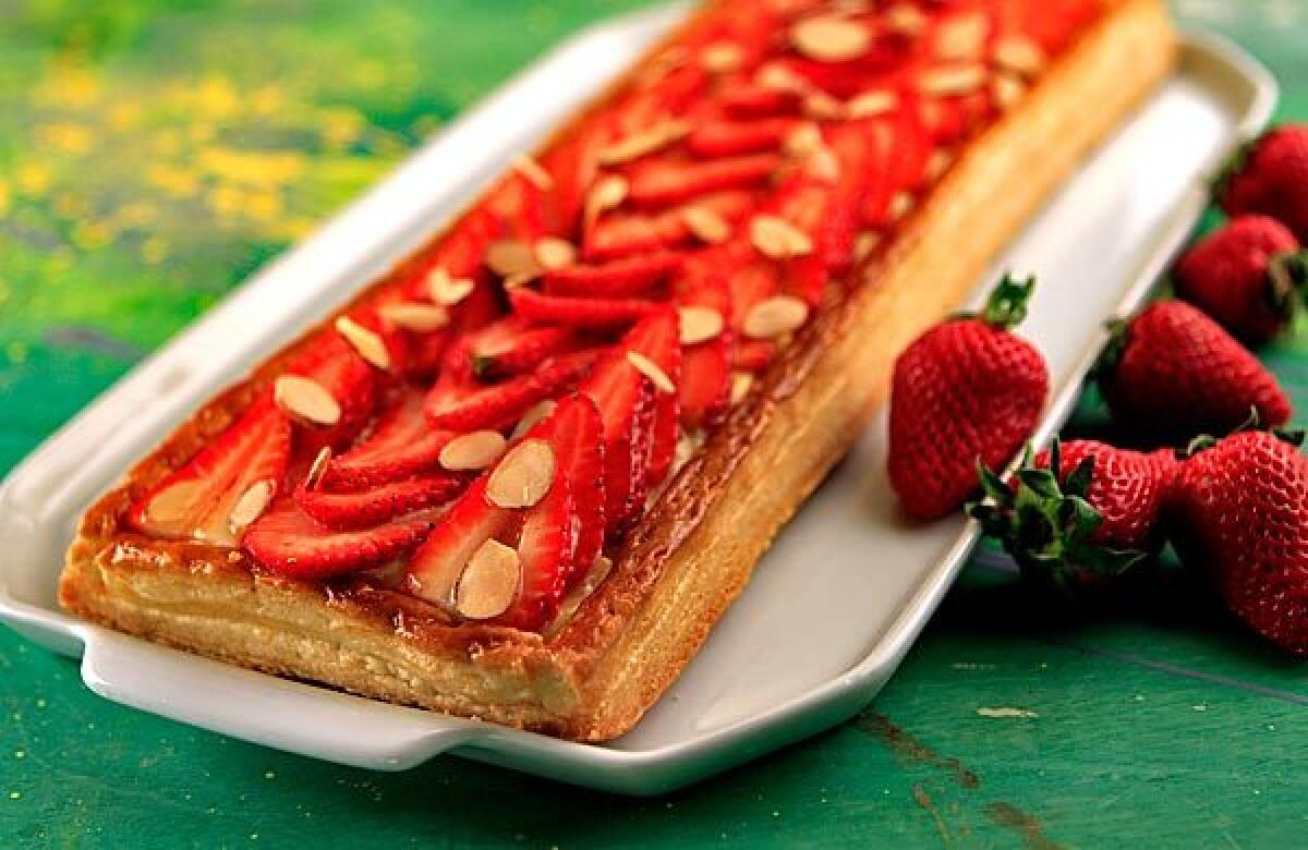 Fresh berry tart has a bed of custard between the flaky puff pastry and the berries.