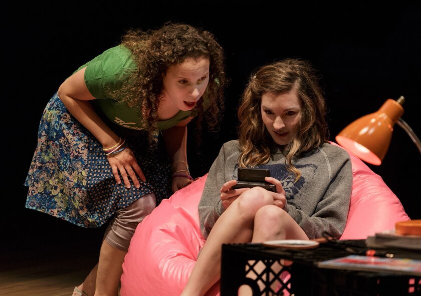 Katie (Cristina Gerla-left) watches as Crystal (Kate Sapper) seeks info on her cell phone in ‘Kingdom City.’