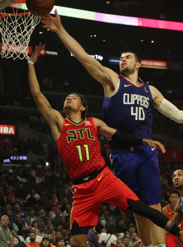 Clippers center Ivica Zubac (40) blocks a shot by Atlanta Hawks guard Trae Young.