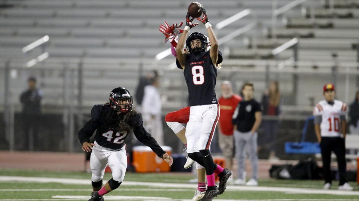 Centennial linebacker Tuasivi Nomura (42) watches as teammate Chris Venable intercepts a pass during the first quarter on Oct. 20, 2017.