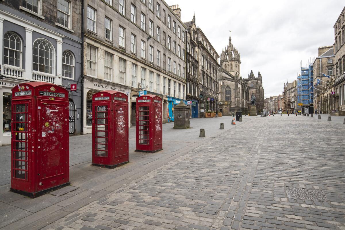 The Royal Mile in Edinburgh, Scotland, was deserted Saturday, the day after Boris Johnson ordered pubs and restaurants across the U.K. to close.