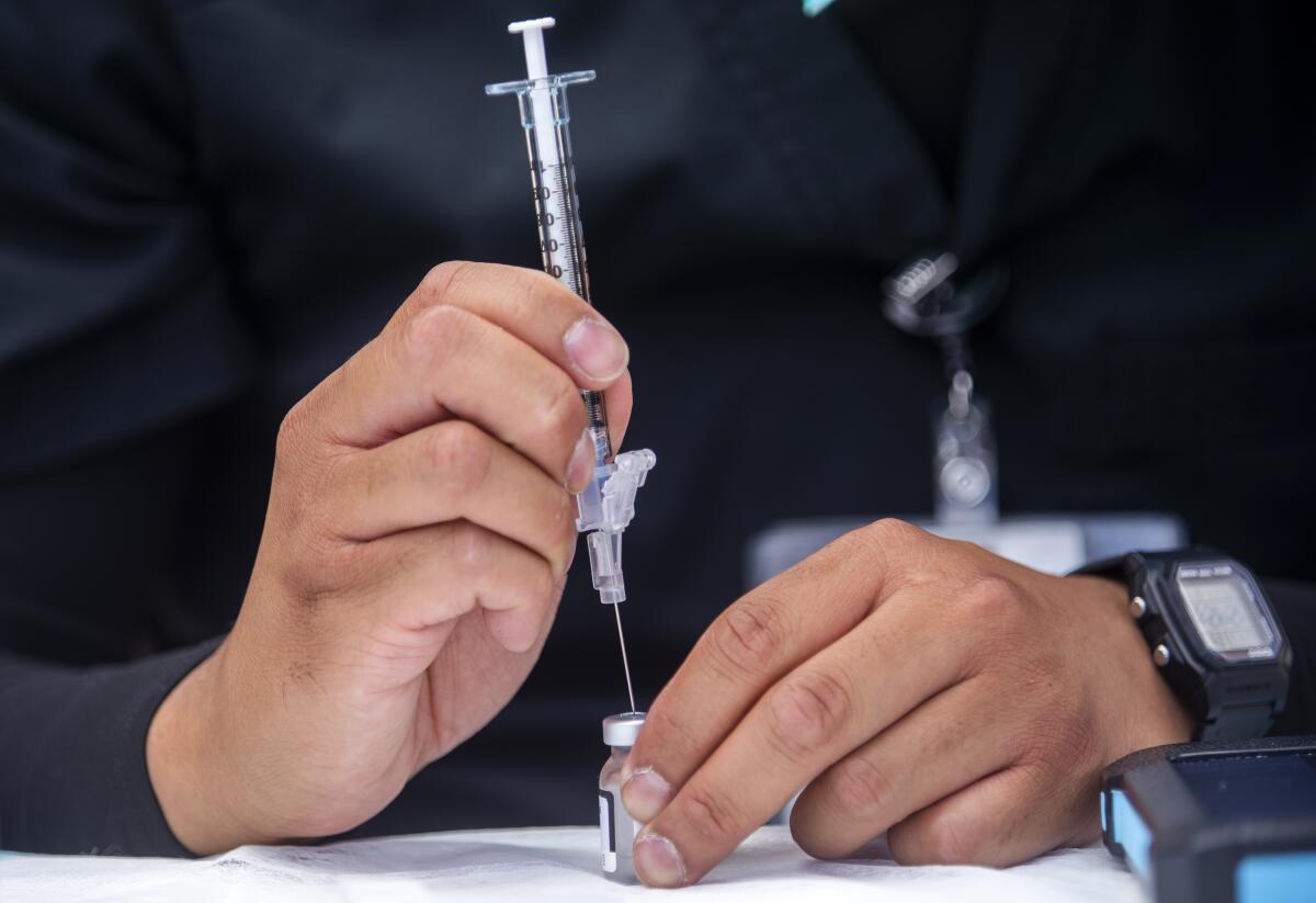 A COVID-19 vaccine dose being prepared