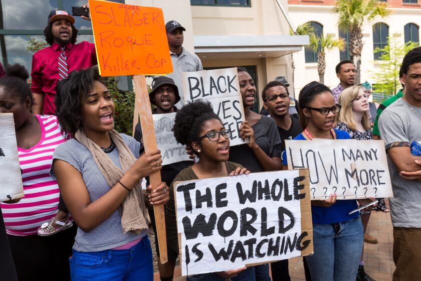 People participate in a rally to protest the killing of Walter Scott.