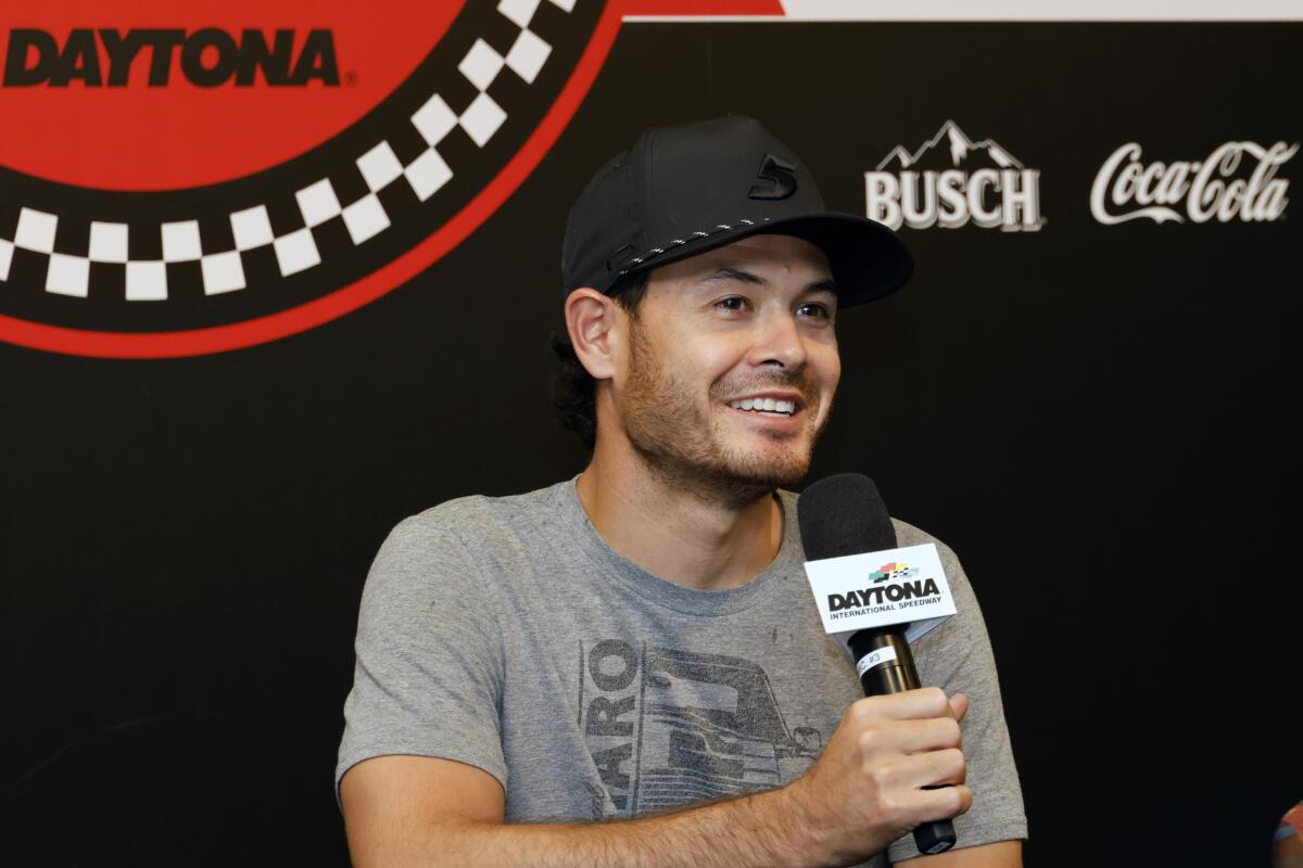 Kyle Larson answers a question from a reporter during a media availability before a NASCAR Cup Series auto race at Daytona International Speedway, Saturday, Aug. 27, 2022, in Daytona Beach, Fla. (AP Photo/Terry Renna)