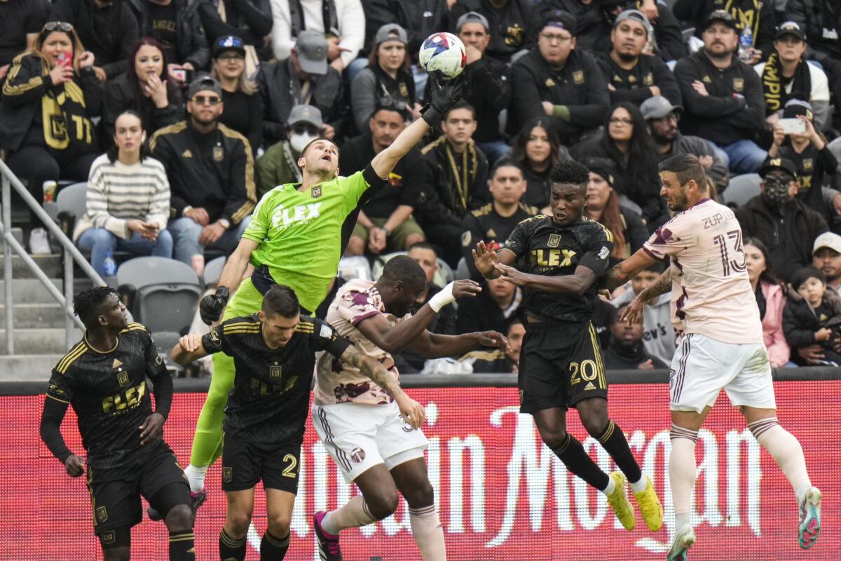 LAFC goalkeeper John McCarthy, top, reaches for the ball during the second half against the Portland Timbers.