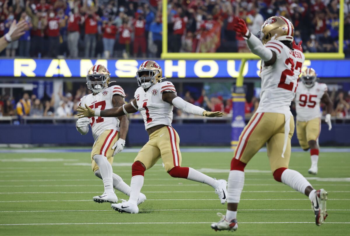 San Francisco 49ers Dre Greenlaw (57), Jimmie Ward (1) and Dontae Johnson (27) react after beating the Rams in overtime.