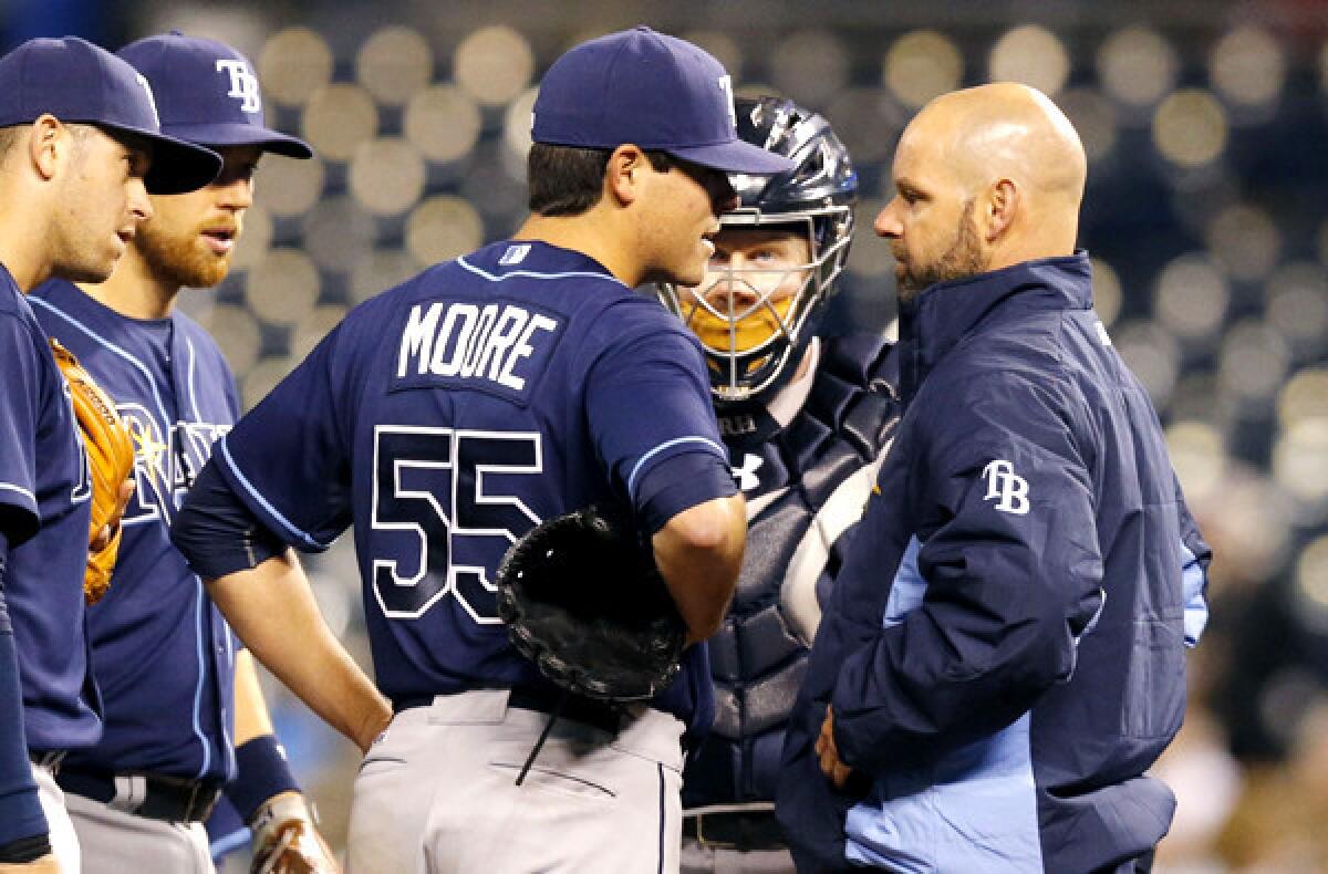 Rays starting pitcher Matt Moore (55) talks with a trainer after sustaining an injury during the fifth inning of a game against the Kansas City Royals on Monday.