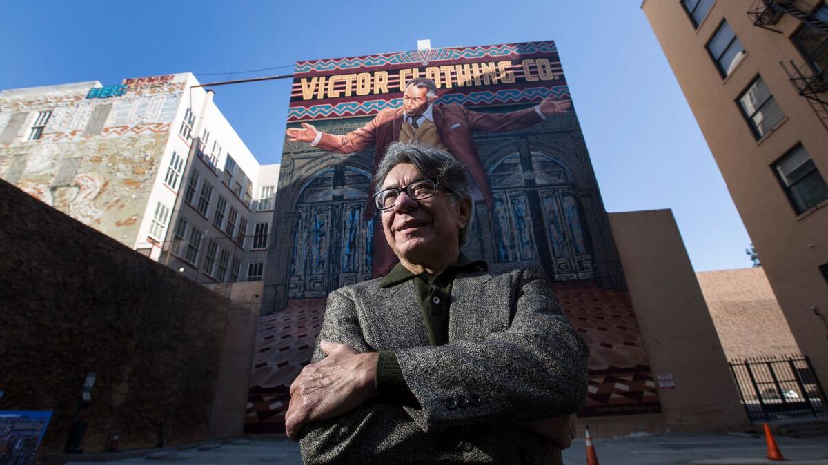 Artist Eloy Torrez and his newly restored downtown mural of Anthony Quinn, the "Pope of Broadway."