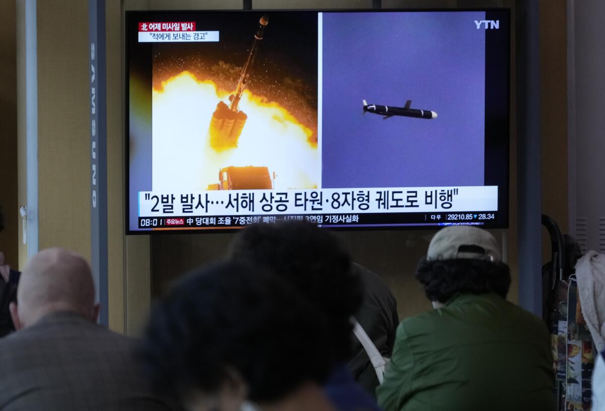A TV screen show images of a missile launch.