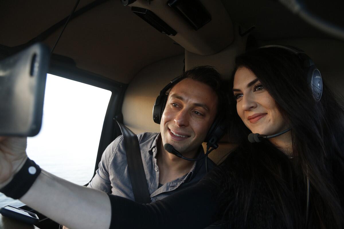 Blind daters Scott Schindler and Zlata Sushchik take a selfie together while flying over San Diego on a Romance Tour provided by Corporate Helicopters.(David Brooks / Union-Tribune)