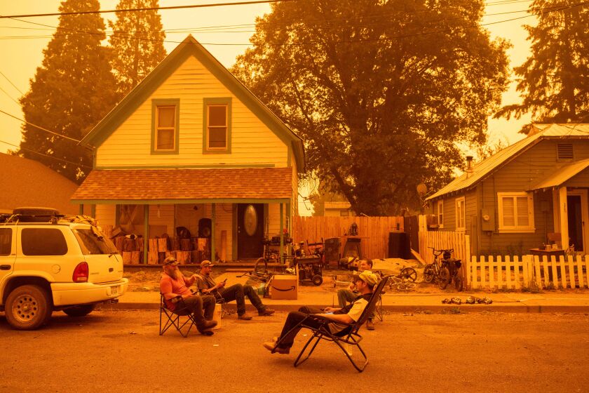 Residents drink and listen to country music in the street while ignoring a mandatory evacuation order as the Dixie fire approaches in Greenville, California on July 23, 2021. - The Dixie fire, which started only a few miles from the deadly Camp fire, has churned through nearly150,000 acres and continues to burn towards rural communities. (Photo by JOSH EDELSON / AFP) (Photo by JOSH EDELSON/AFP via Getty Images)
