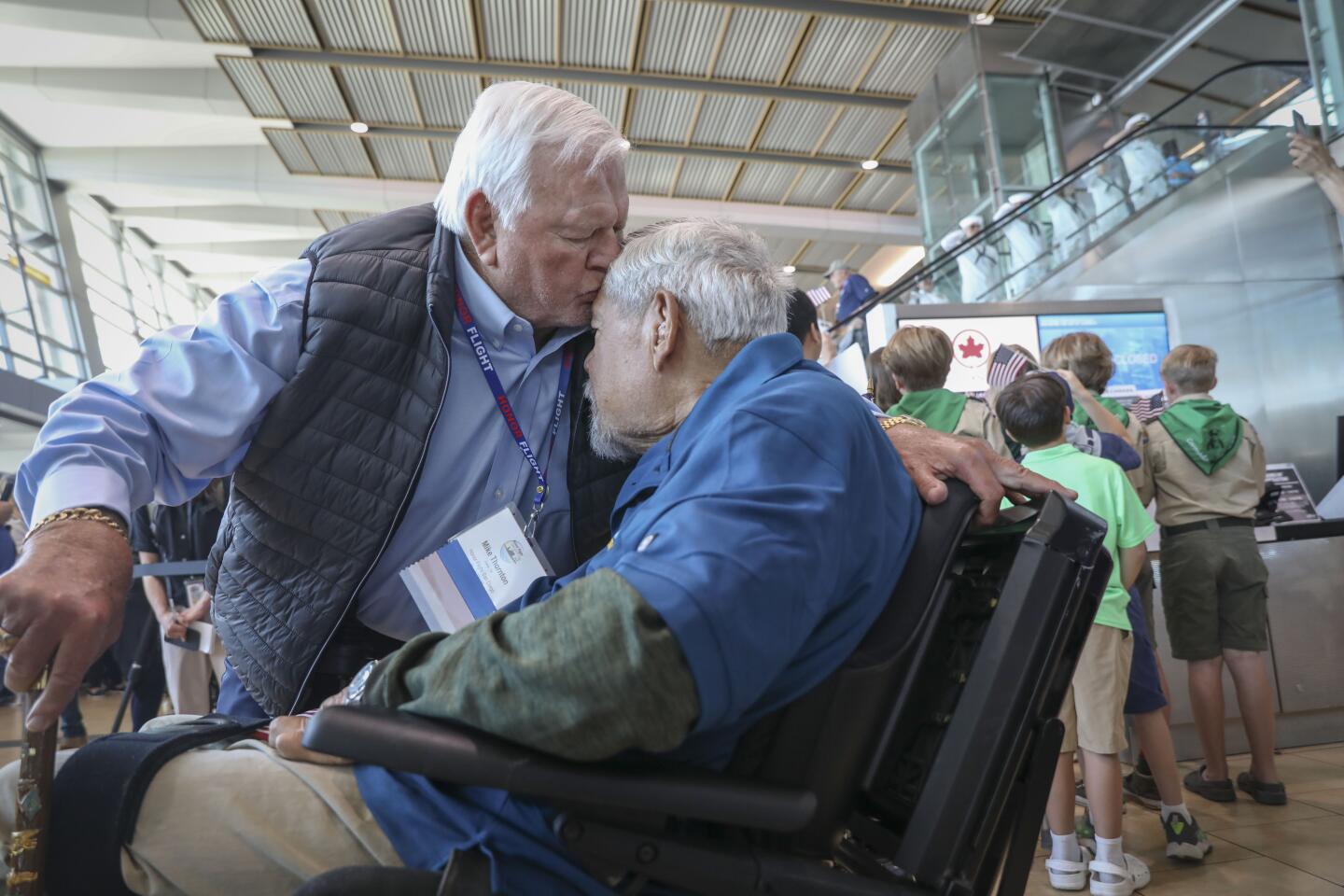 Navy Medal of Honor recipient Veteran Mike Thornton, a retired Navy Seal, greets fellow Navy Seal Moki Martin after arriving back in San Diego from an Honor Flight tour, at the San Diego International Airport on Sunday, April 28, 2024.