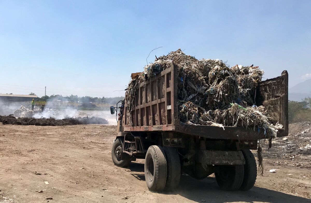 A truck carrying a load of plastic scrap arrives in Bangun, Indonesia.