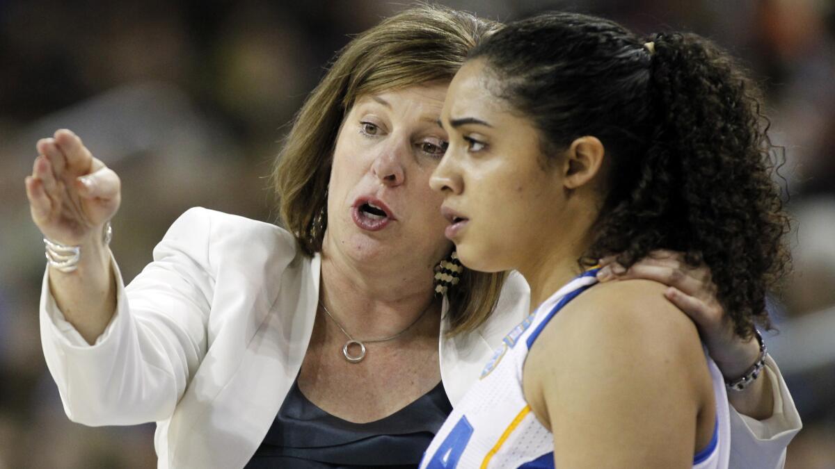UCLA Coach Cori Close, left, speaks to freshman guard Recee' Caldwell during a loss to Notre Dame on Sunday.