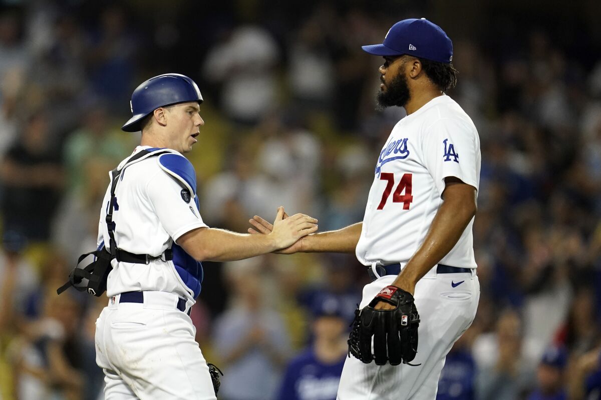Los Angeles Dodgers catcher Will Smith and relief pitcher Kenley Jansen (74) celebrate the team's 4-3 win over the Pittsburgh Pirates in a baseball game Tuesday, Aug. 17, 2021, in Los Angeles. (AP Photo/Marcio Jose Sanchez)