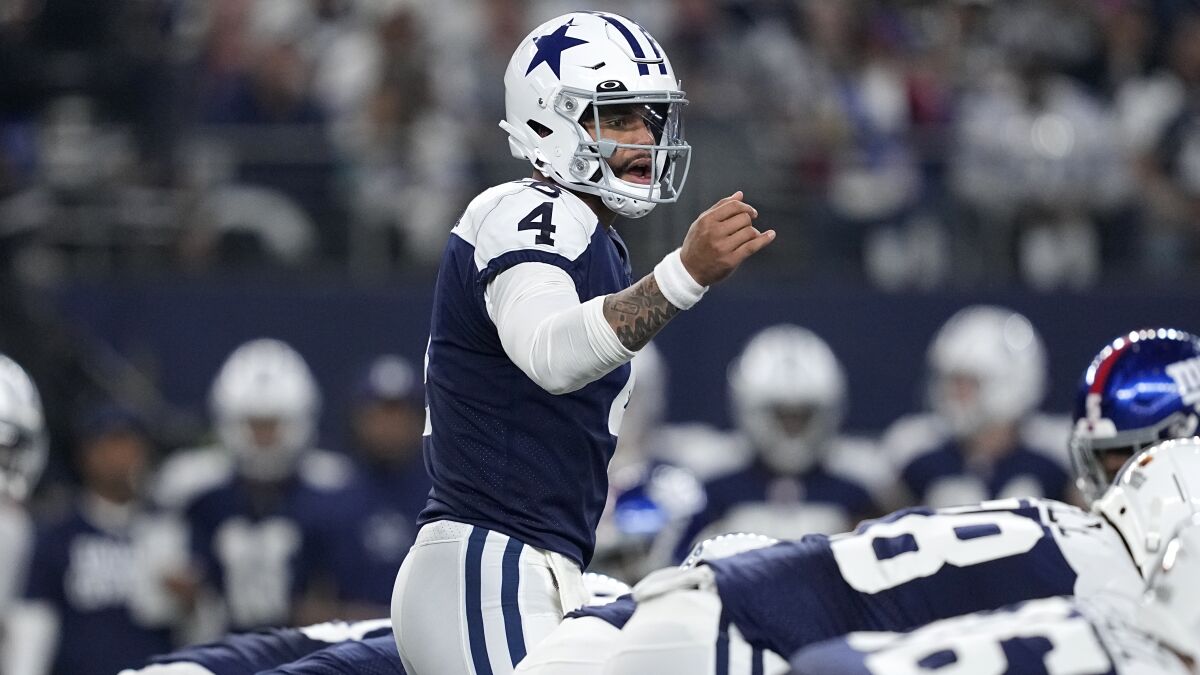 Dallas Cowboys quarterback Dak Prescott signals at the line of scrimmage during a game against the New York Giants.