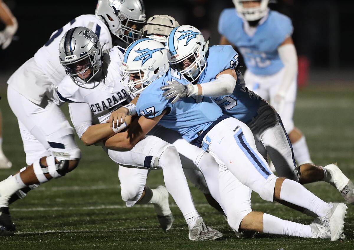 Corona del Mar's Cannon Pohlig (17) and Ryan Nielsen (45) sack quarterback Dash Beierly for a loss.