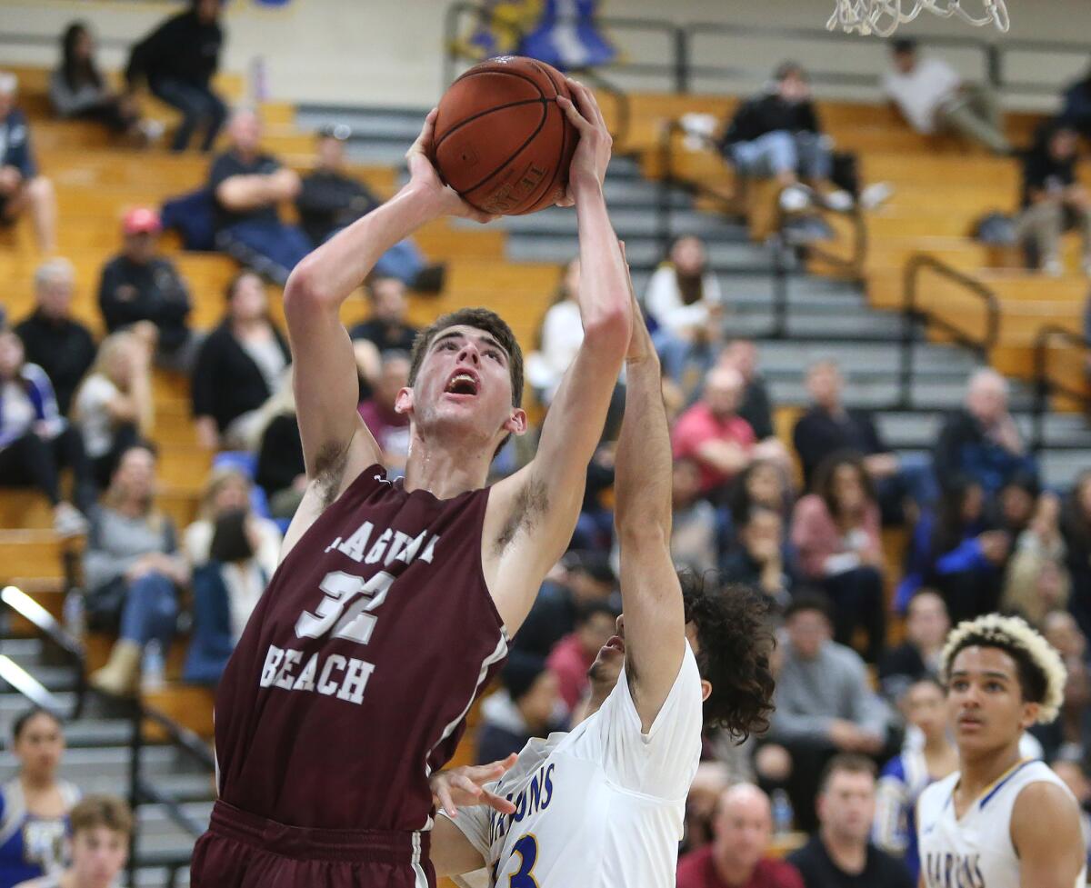 Laguna Beach's Nolan Naess drives to the basket for a layup during a Wave League game at Fountain Valley on Wednesday.