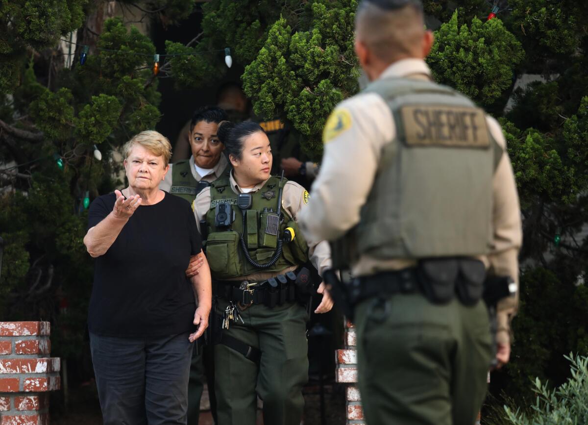 Law enforcement officers escort a person.