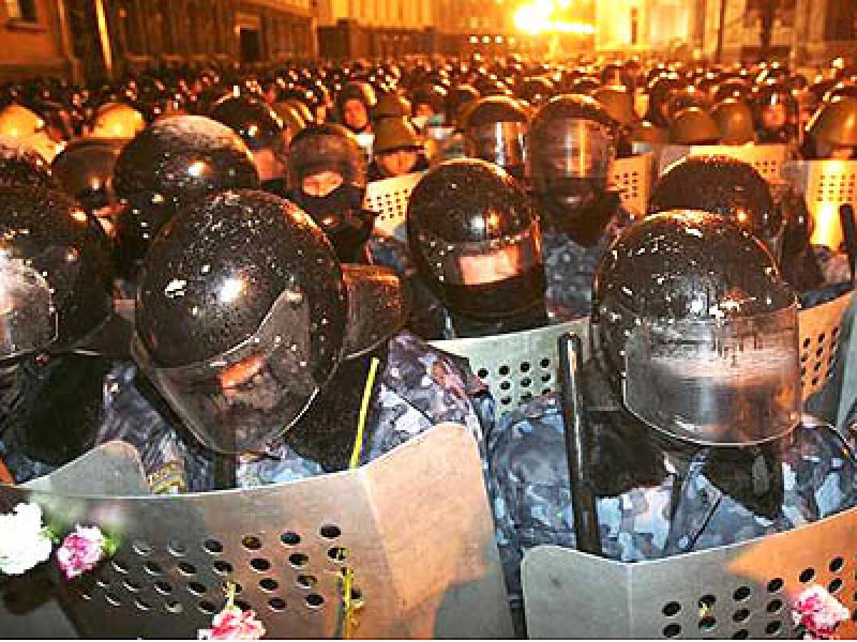 Riot police mass outside the presidential offices in Kiev, the Ukrainian capital. Opposition backers left carnations in the shields during a face-off that remained nonviolent.