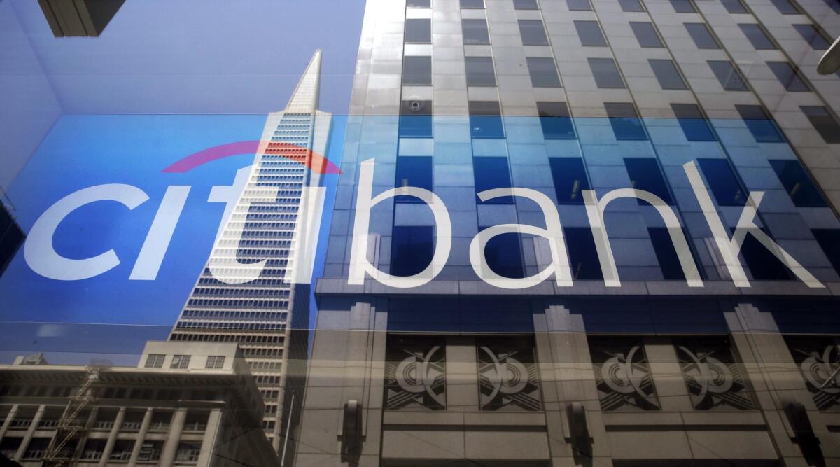The Transamerica Pyramid is reflected in the window of a Citibank branch in San Francisco. 