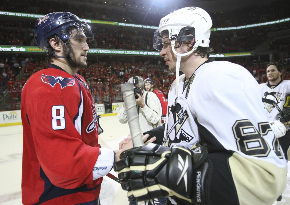 Capitals forward Alex Ovechkin (8) shakes hands with Penguins forward Sidney Crosby (87) following Game 7 of a second-round playoff series in 2009.