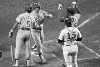 Dodgers' Ron Cey is congratulated by teammates Steve Garvey , left, and Reggie Smith.