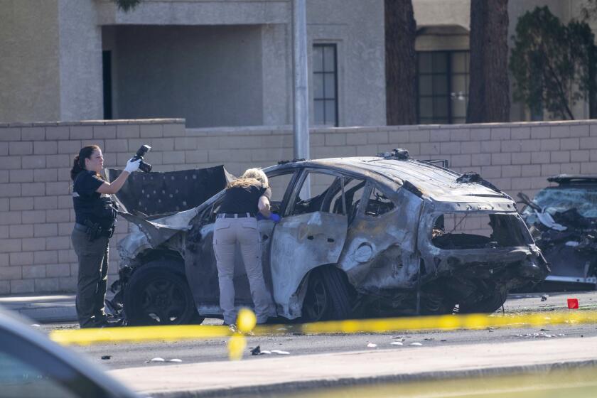 Police investigators work at the scene of a fatal crash Tuesday in Las Vegas. 