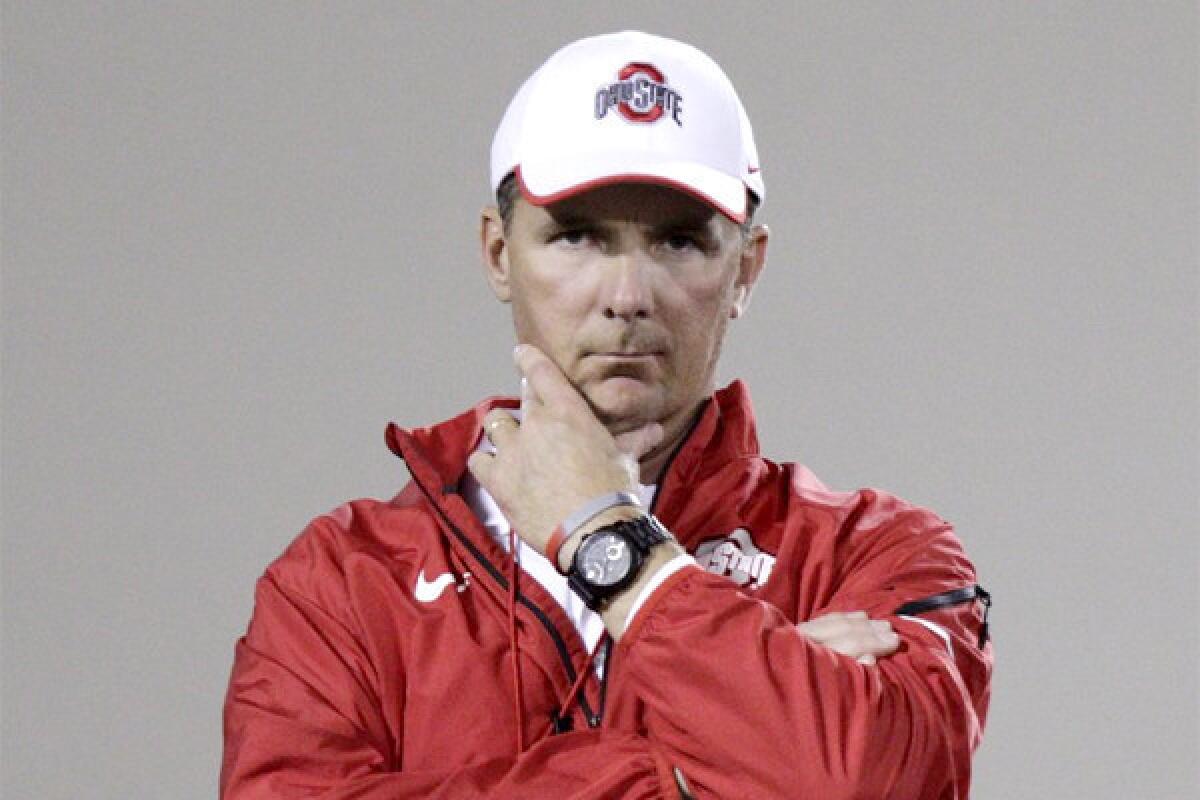 Ohio State Coach Urban Meyer concealed the scar from a surgery to drain a cyst on his brain under a hat at the Buckeyes' first spring practice Tuesday.