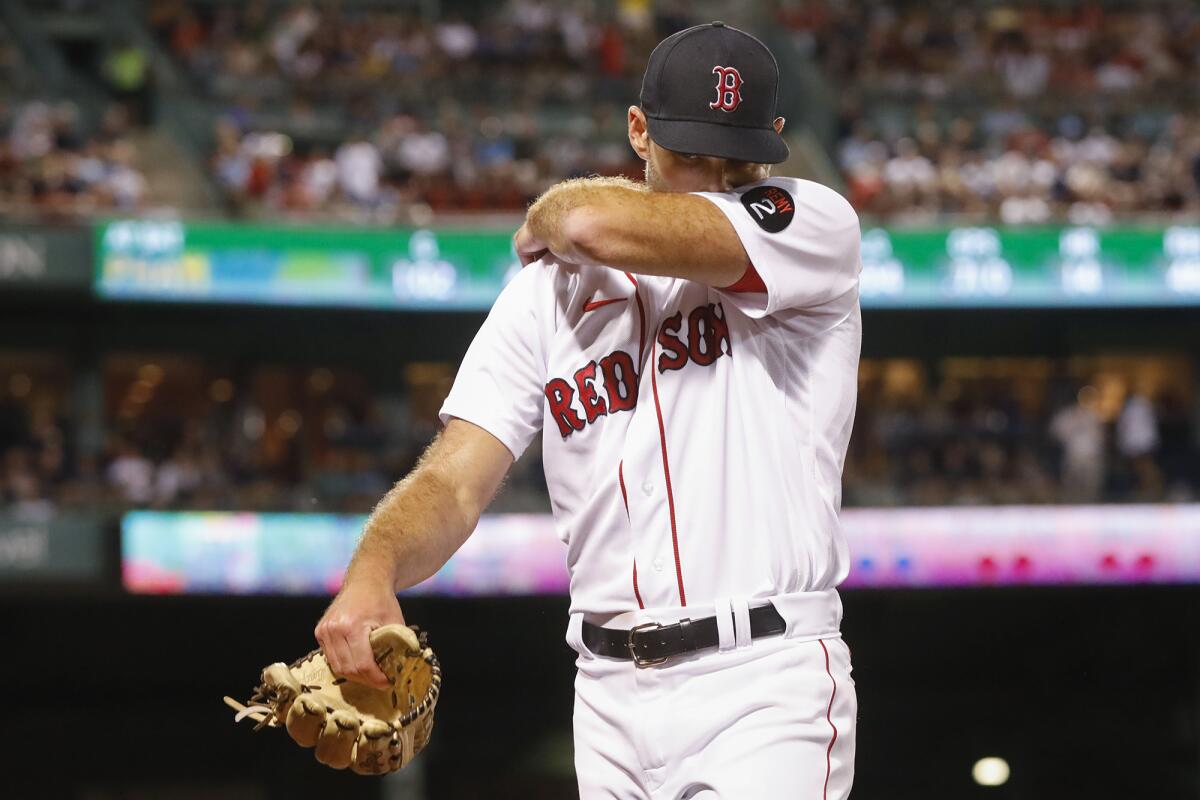 Boston Red Sox pitcher Michael Wacha wipes his face as he walks off the mound against the New York Yankees during the seventh inning at Fenway Park, Sunday, Aug. 14, 2022, in Boston. (AP Photo/Paul Connors)