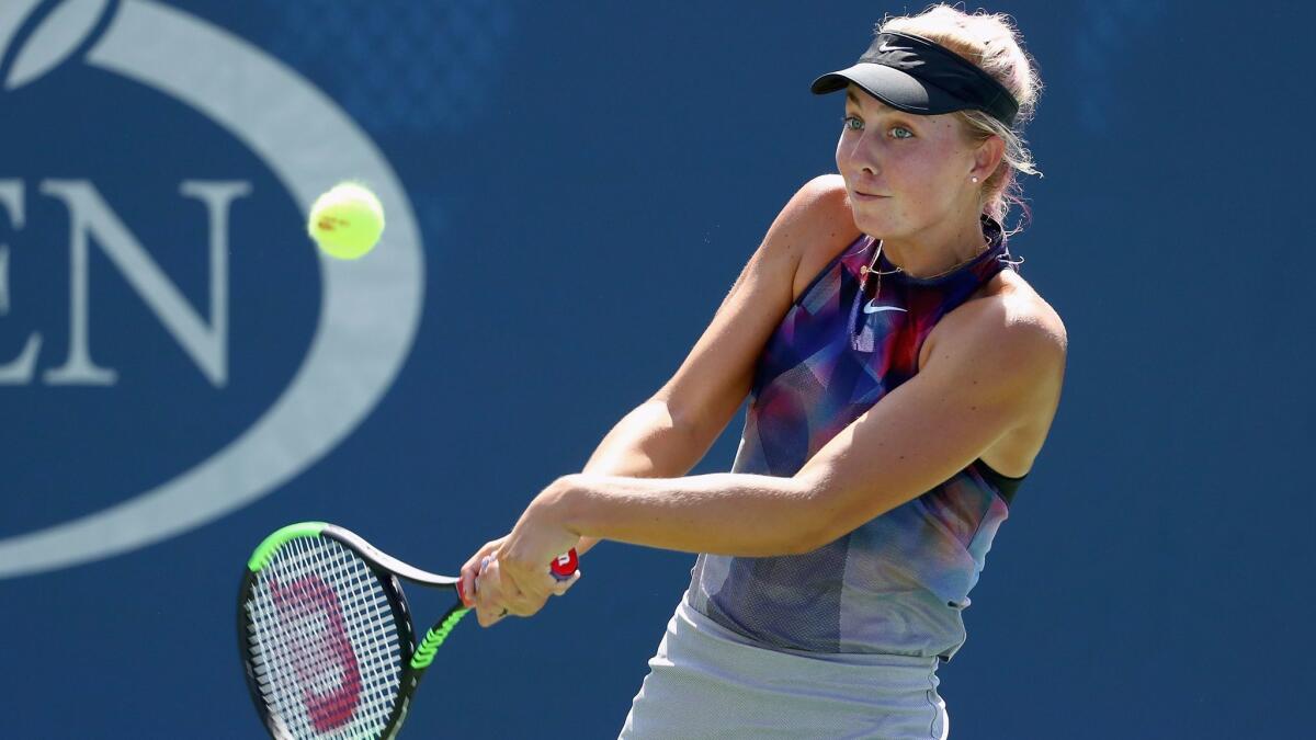 Newport Beach's Ashley Kratzer returns a shot to Tatjana Maria of Germany during their first-round women's singles match at the U.S. Open on Tuesday.