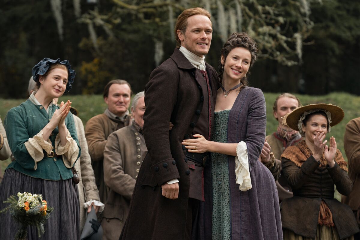 Sam Heughan as Jamie Fraser, with Caitriona Balfe, in a scene from "Outlander."